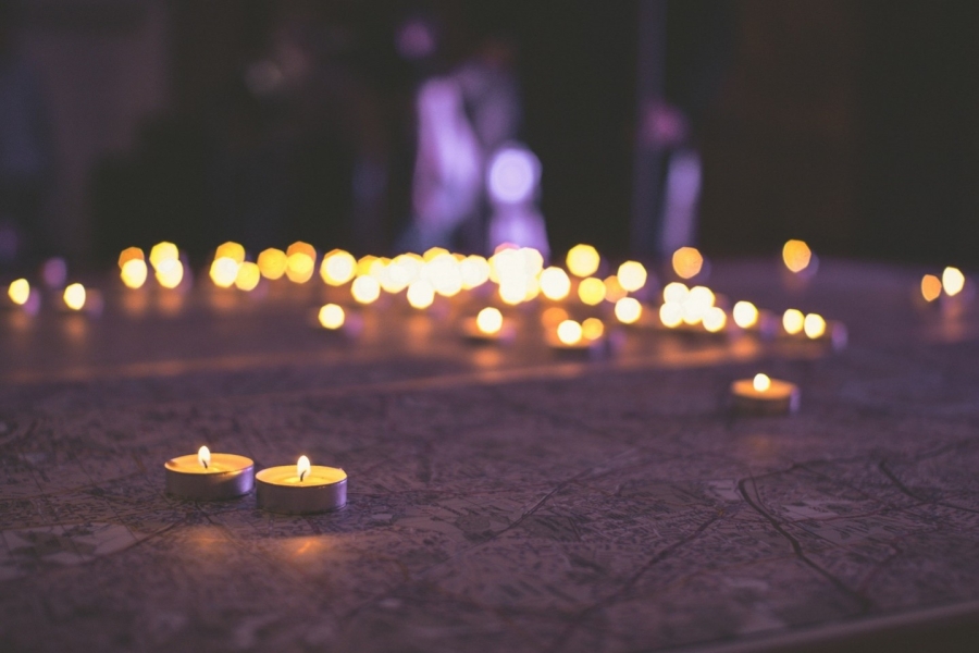 The lights of candles burning in the dark